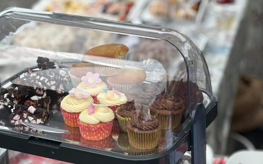 Cupcakes and traybakes in a cake display case
