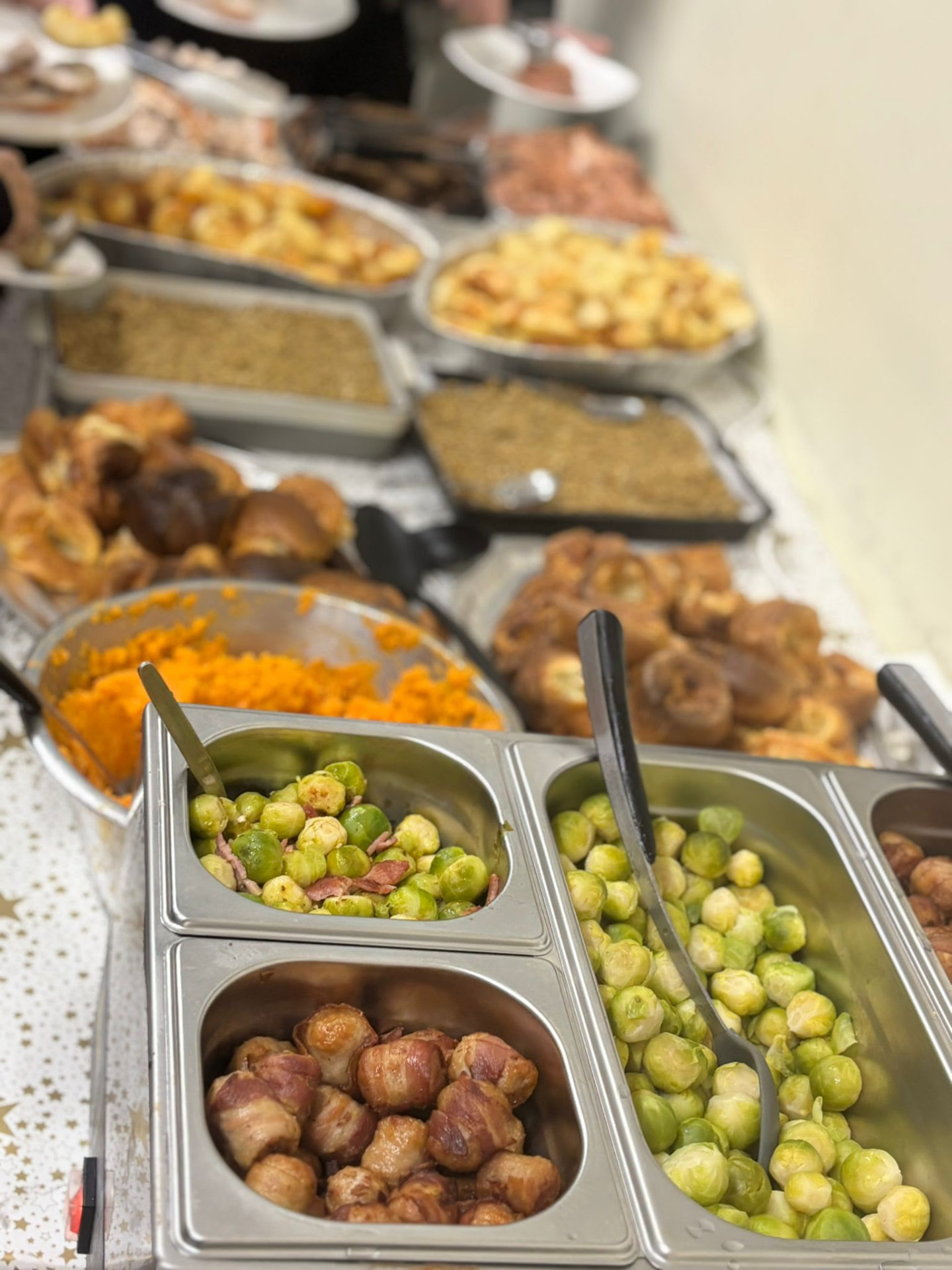 Hot buffet trays laid out for a community meal