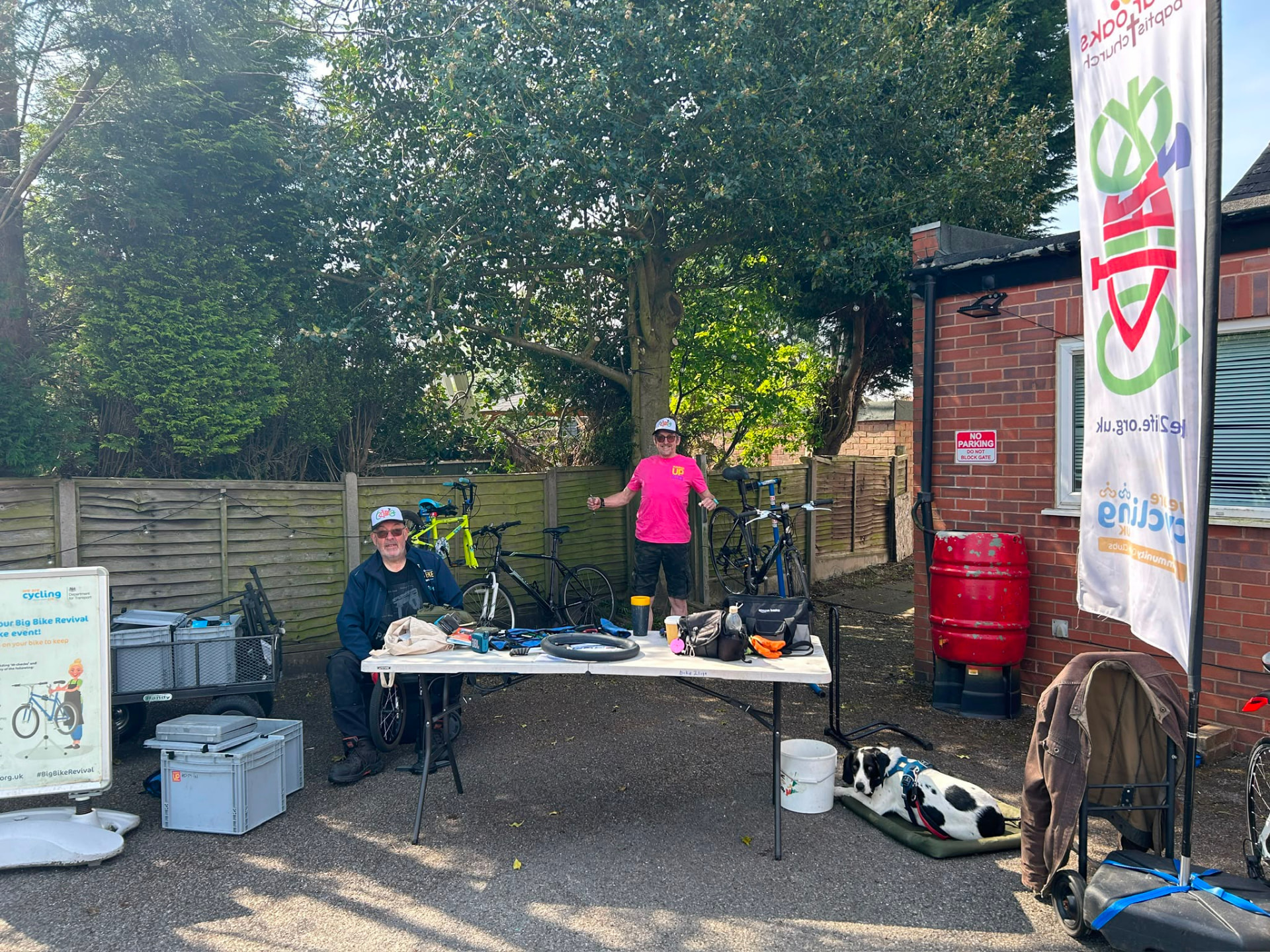 Volunteers running a free bike repair stall in the church car park