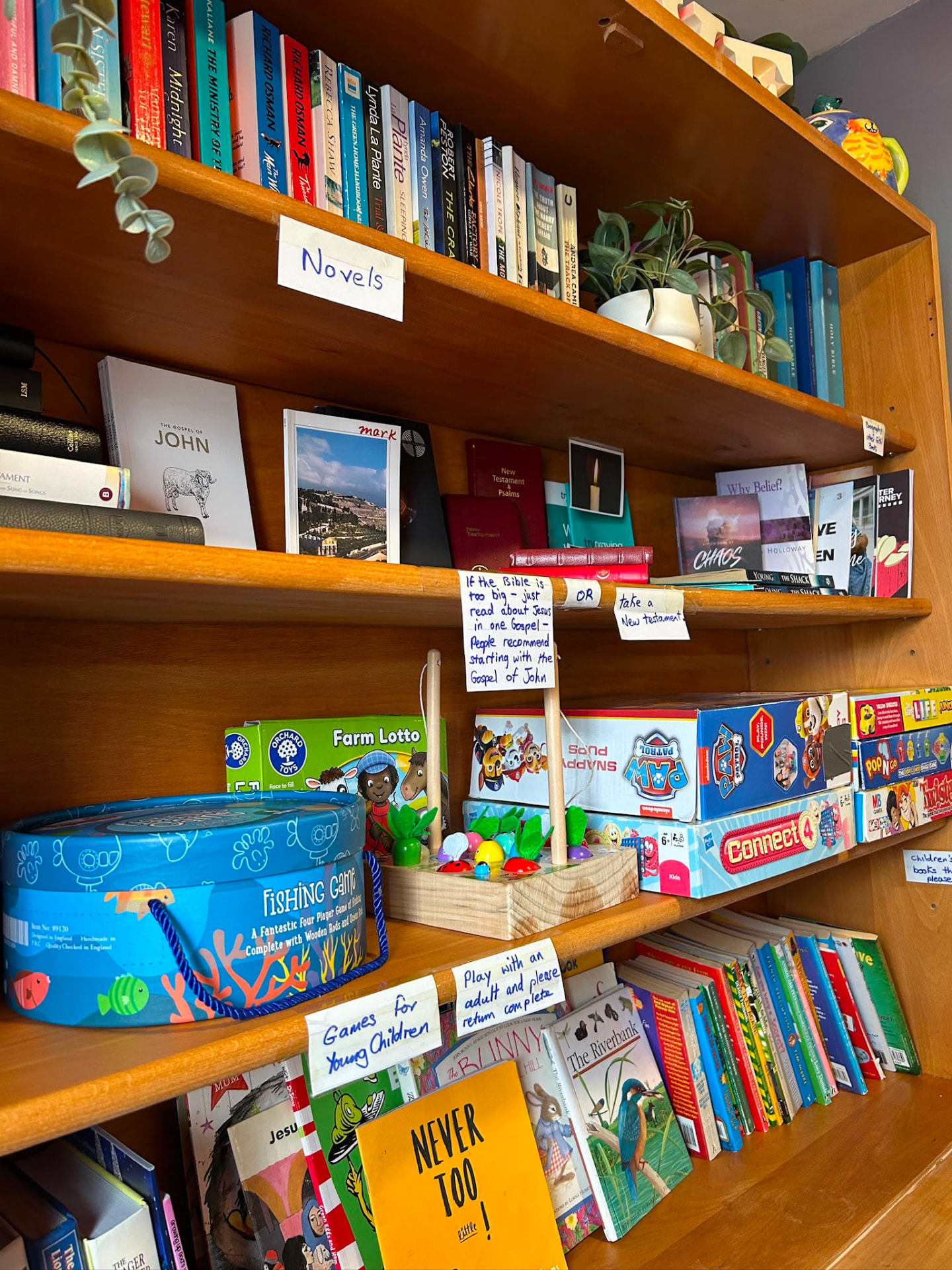 Bookshelf of novels, Bibles and children's games in the church