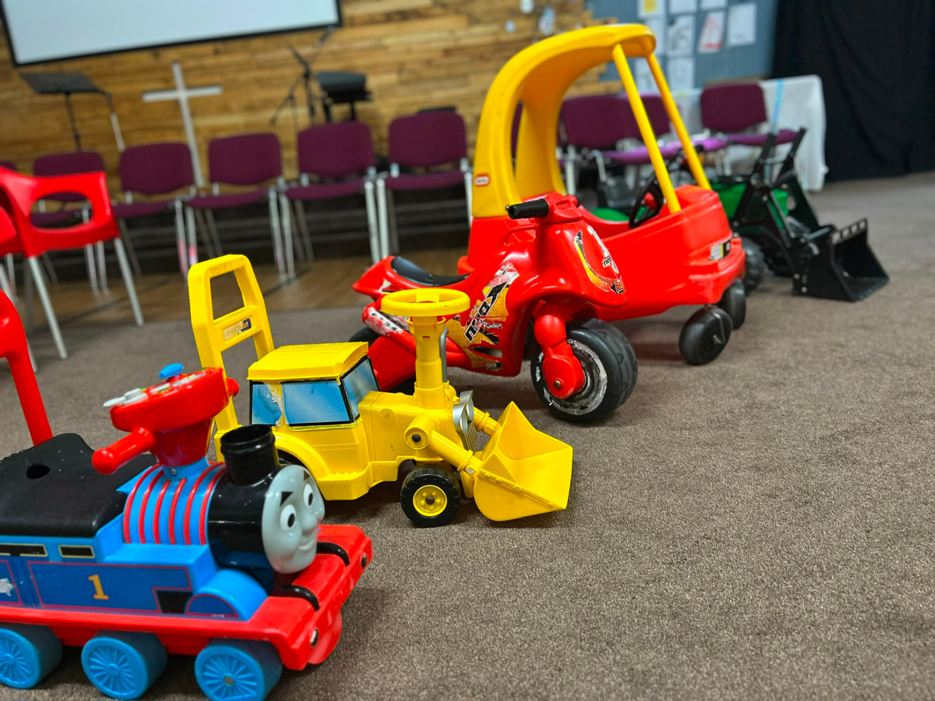 Ride-on toys set out in the church hall for toddlers