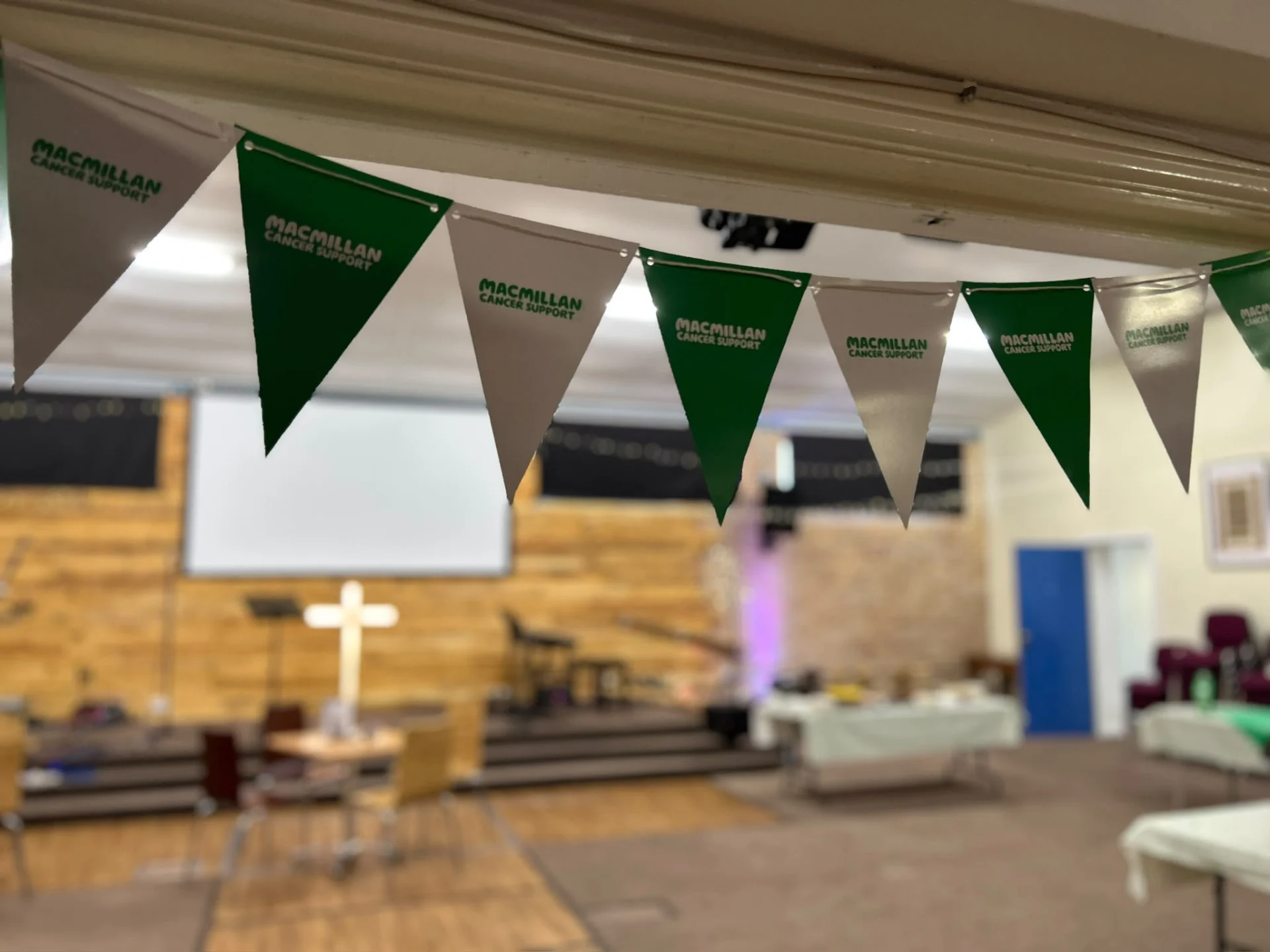 Macmillan Cancer Support bunting hanging across the church hall