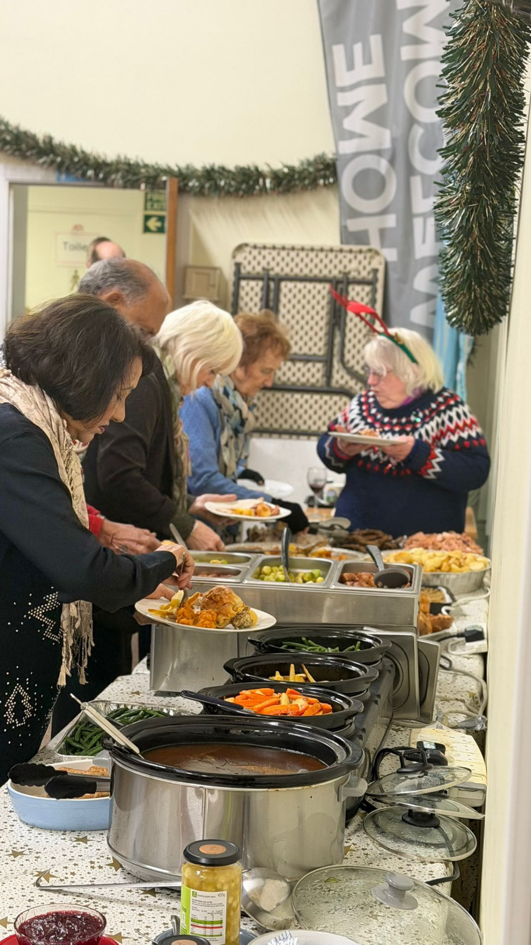People serving themselves from a Christmas buffet