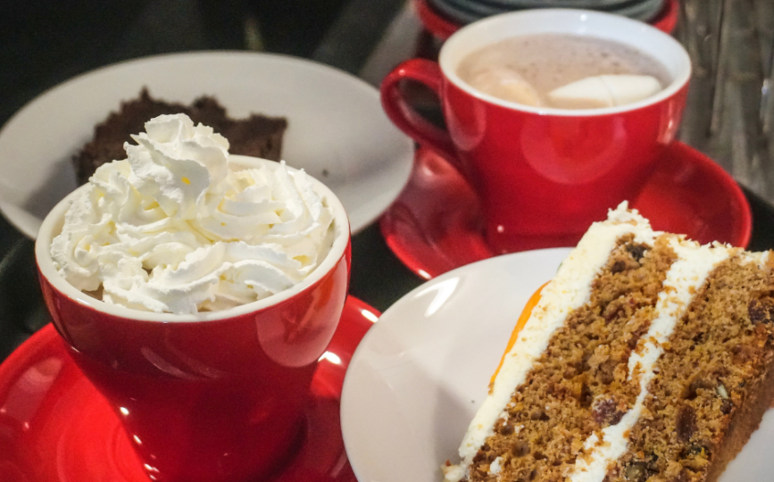 Hot chocolates with cream and a slice of carrot cake