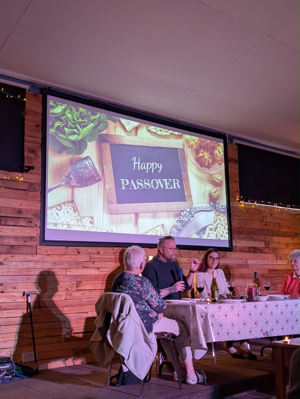 A Passover meal being shared and explained on stage