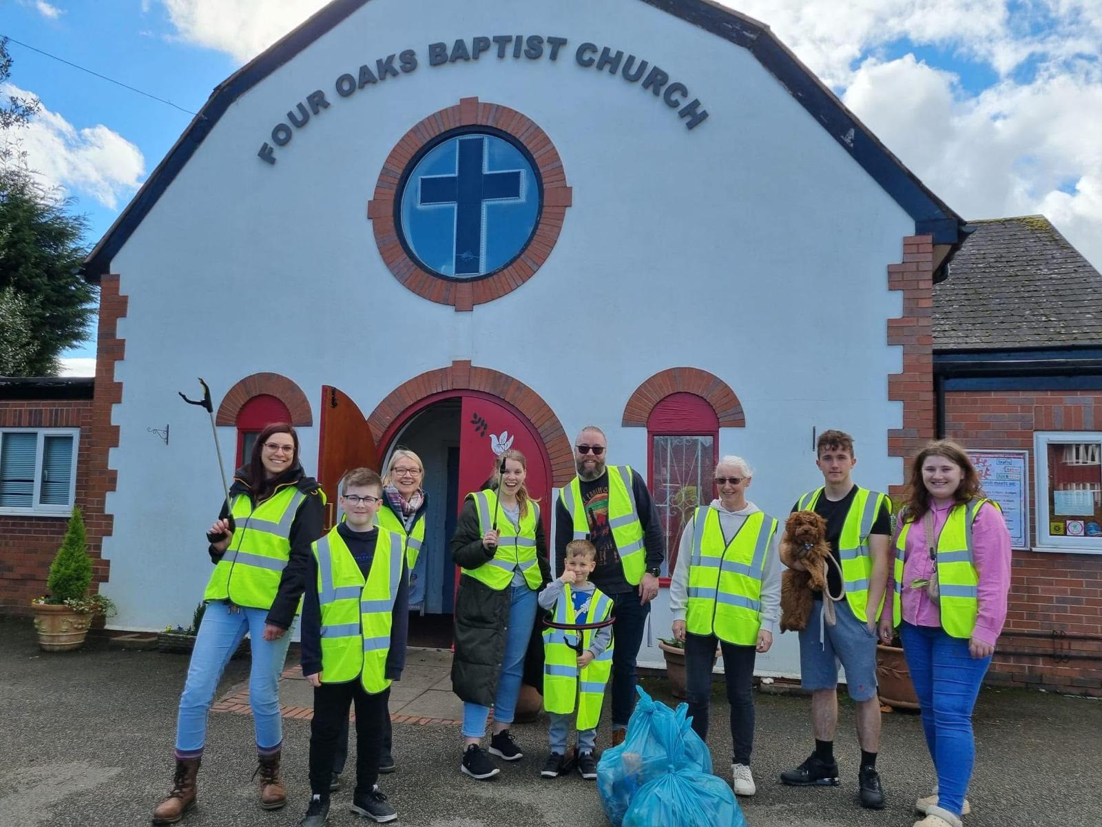 Volunteers in hi-vis vests outside the church before a litter pick