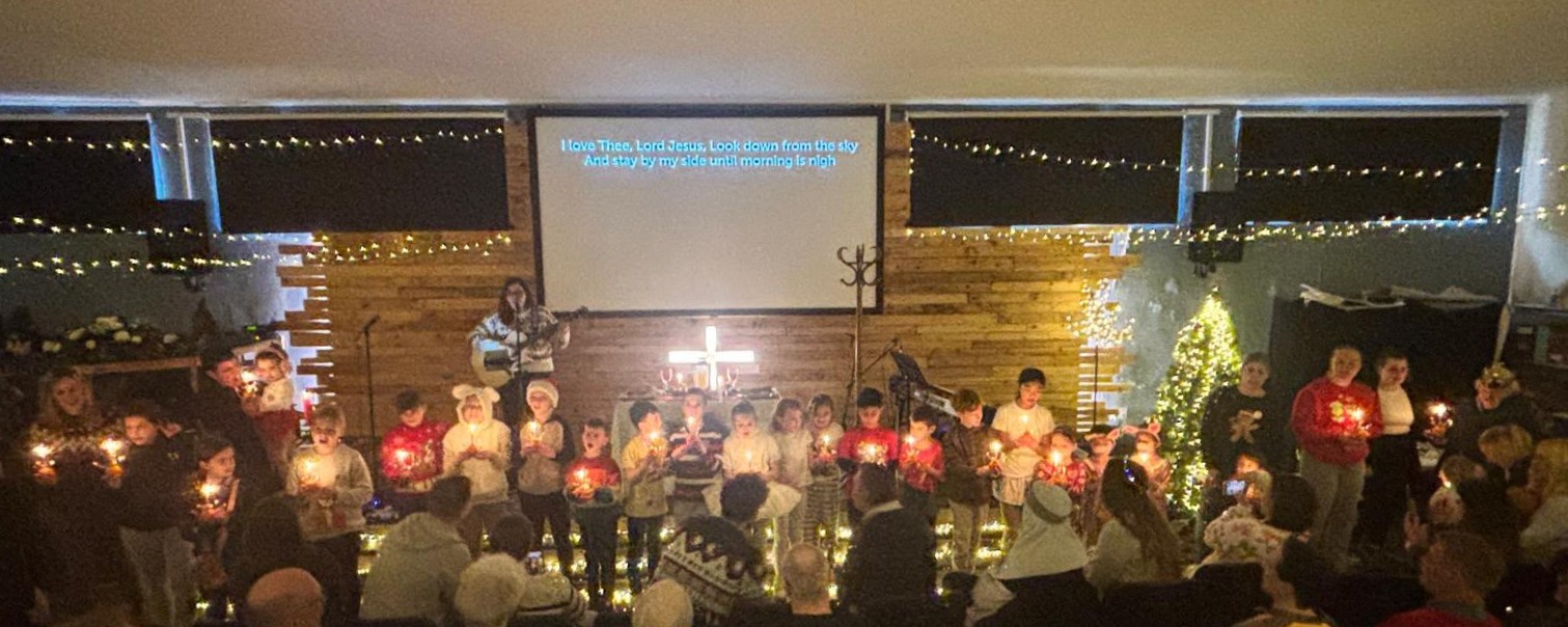 Children holding candles at a Four Oaks Baptist Church carol service